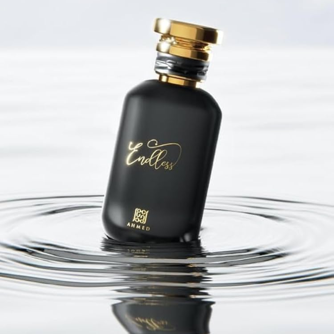 Black perfume bottle with gold cap and 'Endless' branding on a reflective surface. Ahmed Al Maghribi Endless Unisex Perfume
