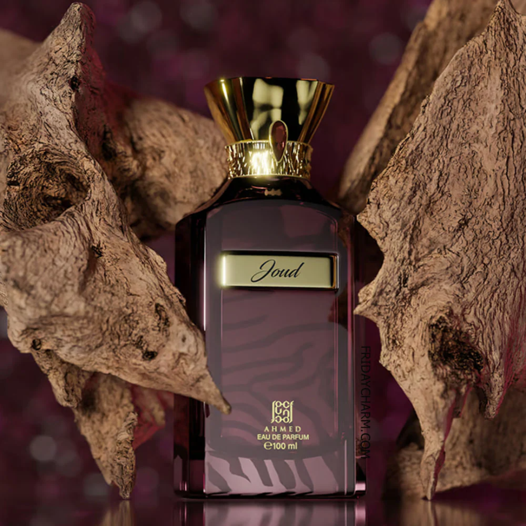 Perfume bottle with gold cap and 'Joud' branding against a textured background. Ahmed Al Maghribi Joud Unisex Perfume