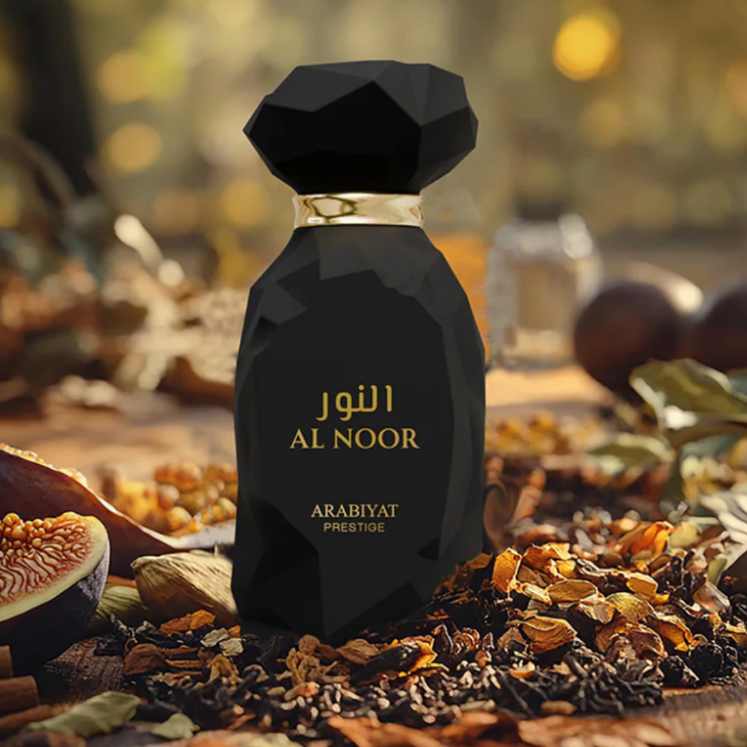 Black perfume bottle labeled 'Al Noor' by Arabiyat Prestige on a textured surface with spices and fruits. Al Noor by Arabiyat Prestige Unisex Perfume