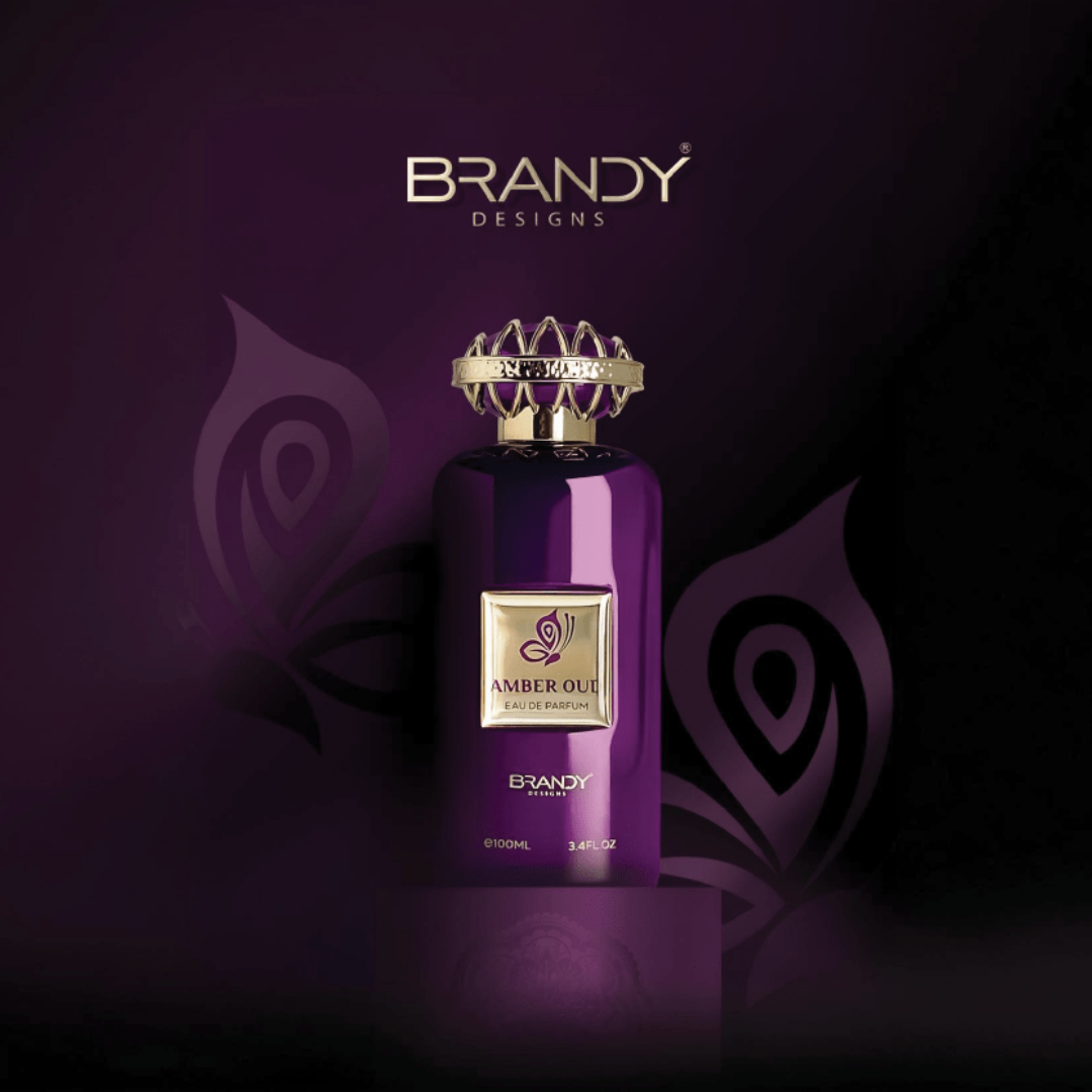 Purple perfume bottle with gold accents on a dark purple background, featuring the brand 'Brandy Designs'. Amber Oud by Brandy Designs Unisex Perfume