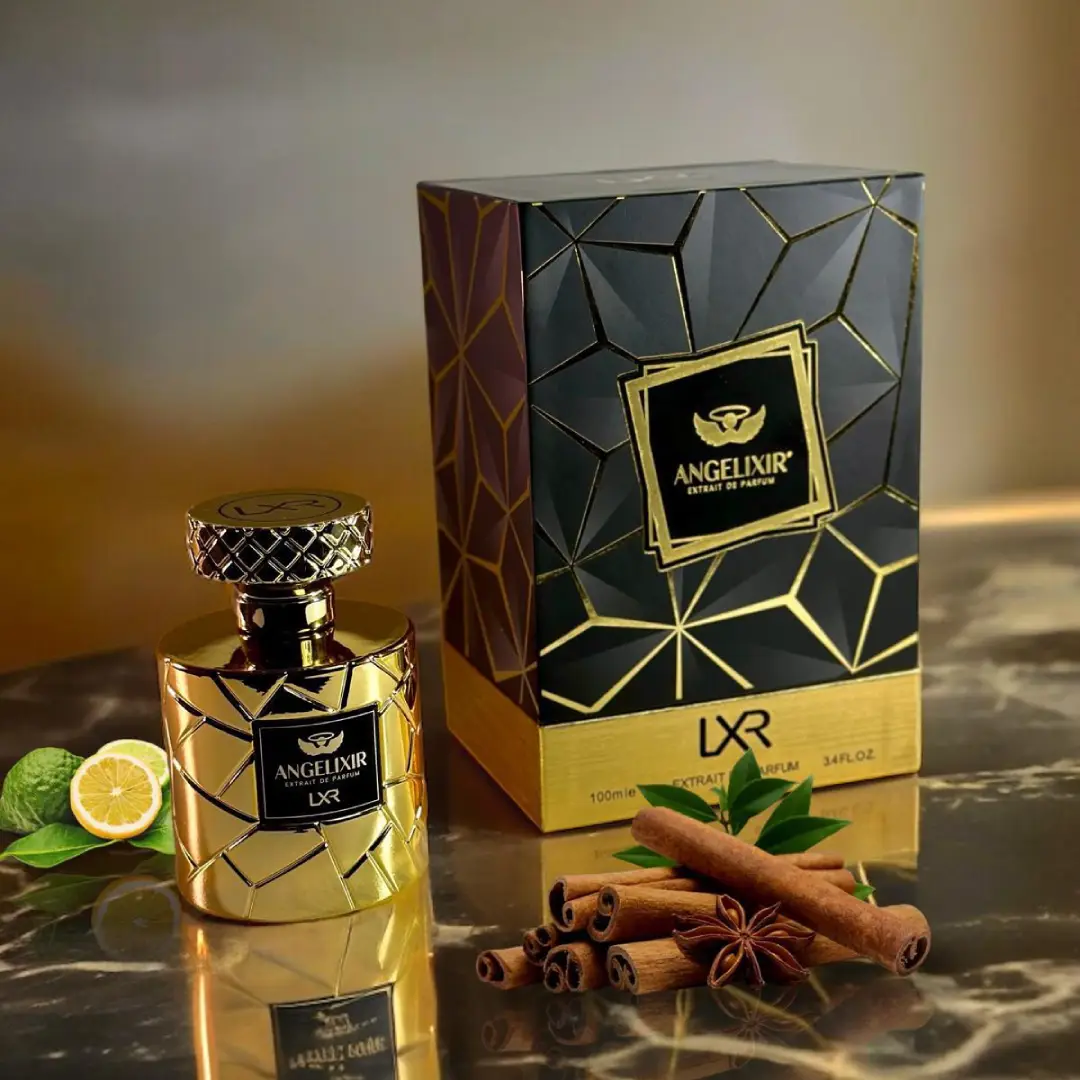 Gold perfume bottle and packaging with geometric design on a reflective surface. Angelixir by LXR Perfumes.