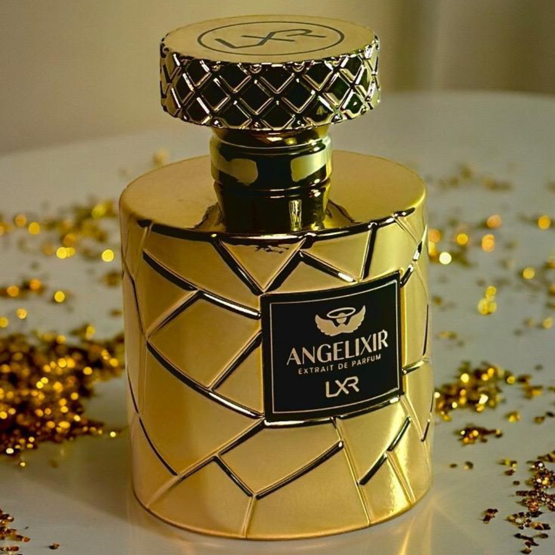 Gold perfume bottle with 'Angelixir' label on a reflective surface with gold confetti. By LXR perfumes.