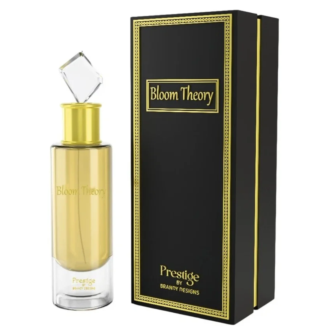 Gold perfume bottle with 'Bloom Theory' branding next to a black box with the same branding. Bloom Theory by Brandy Designs Unisex Perfume.