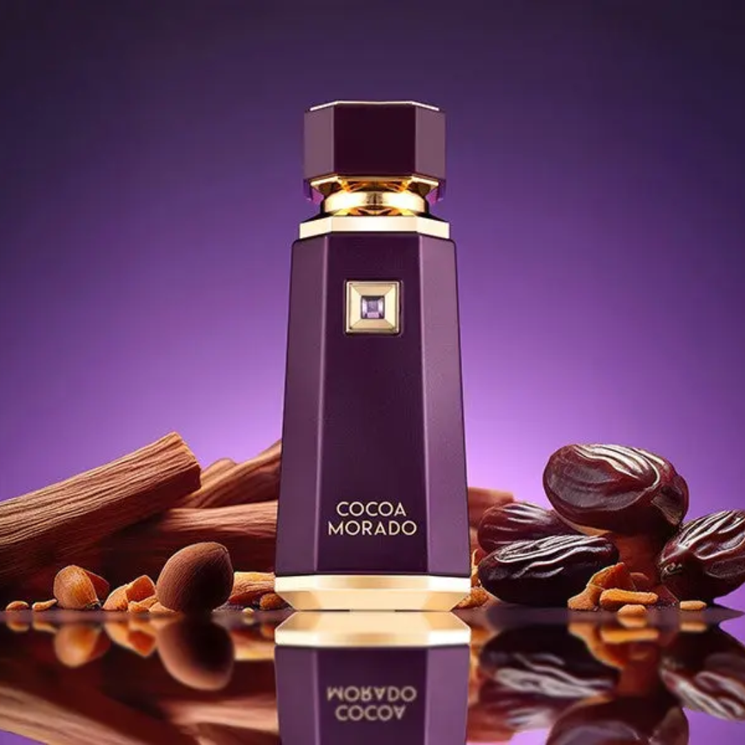 Cocoa Morado perfume bottle with dark chocolate and cinnamon sticks on a purple background