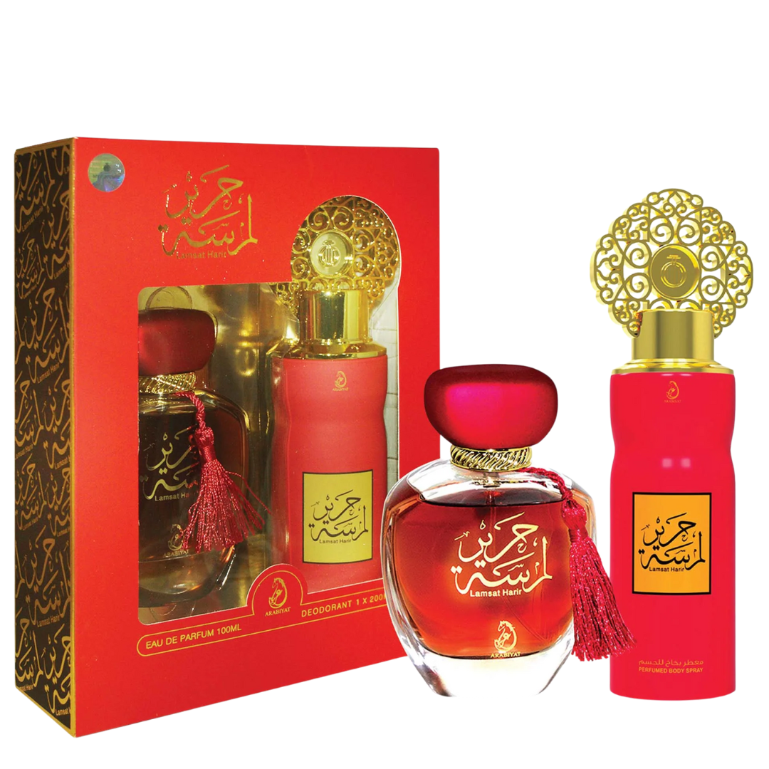 Red perfume bottles with gold caps and decorative packaging on a white background. Lamsat Harir Giftset by Arabiyat Womens Perfume
