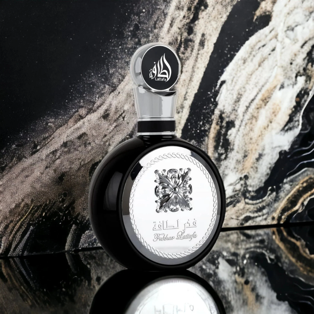Lattafa Fakhar Black Perfume Bottle on Marble Background – Luxury Men’s Fragrance
Striking Lattafa Fakhar Black perfume displayed against a marble-inspired background, symbolizing elegance and power in a masculine scent. Clone / dupe of / inspired by Yves Saint Laurent - Y perfume.