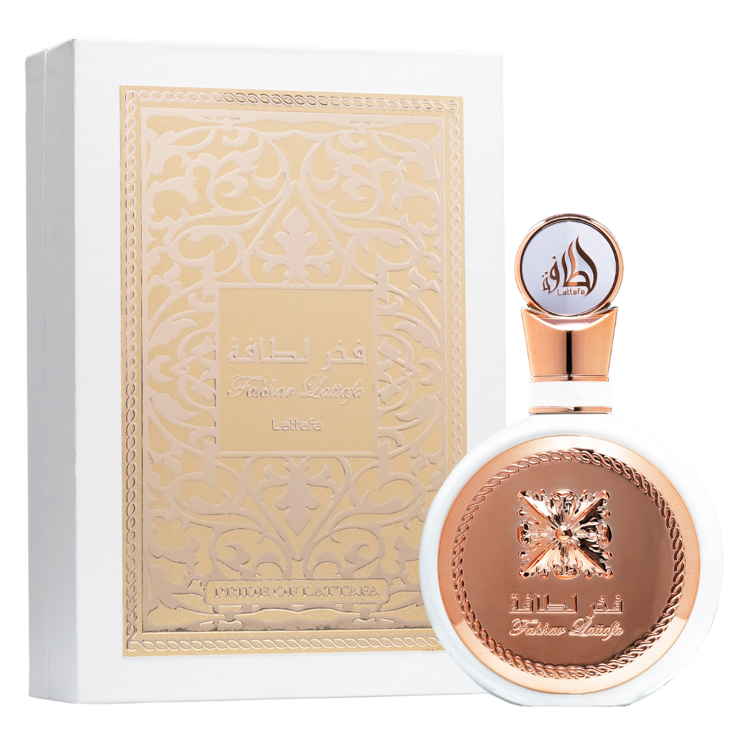A bottle of Fakhar Rose perfume from Lattafa, with a rose gold cap and label featuring an intricate design. Clone / dupe of / inspired by Givenchy - L’Interdit perfume. Lattafa Fakhar Eau de Parfum in luxurious white and gold packaging, showcasing intricate embossed Arabic design and round bottle with rose-gold detailing.