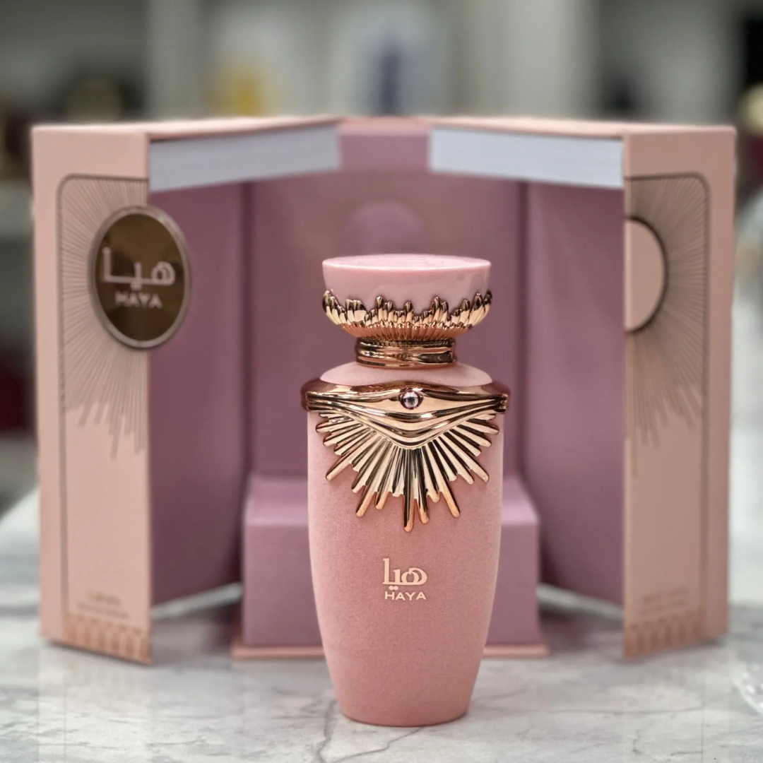 Pink perfume bottle with decorative elements on a marble surface. Lattafa Haya Womens Perfume