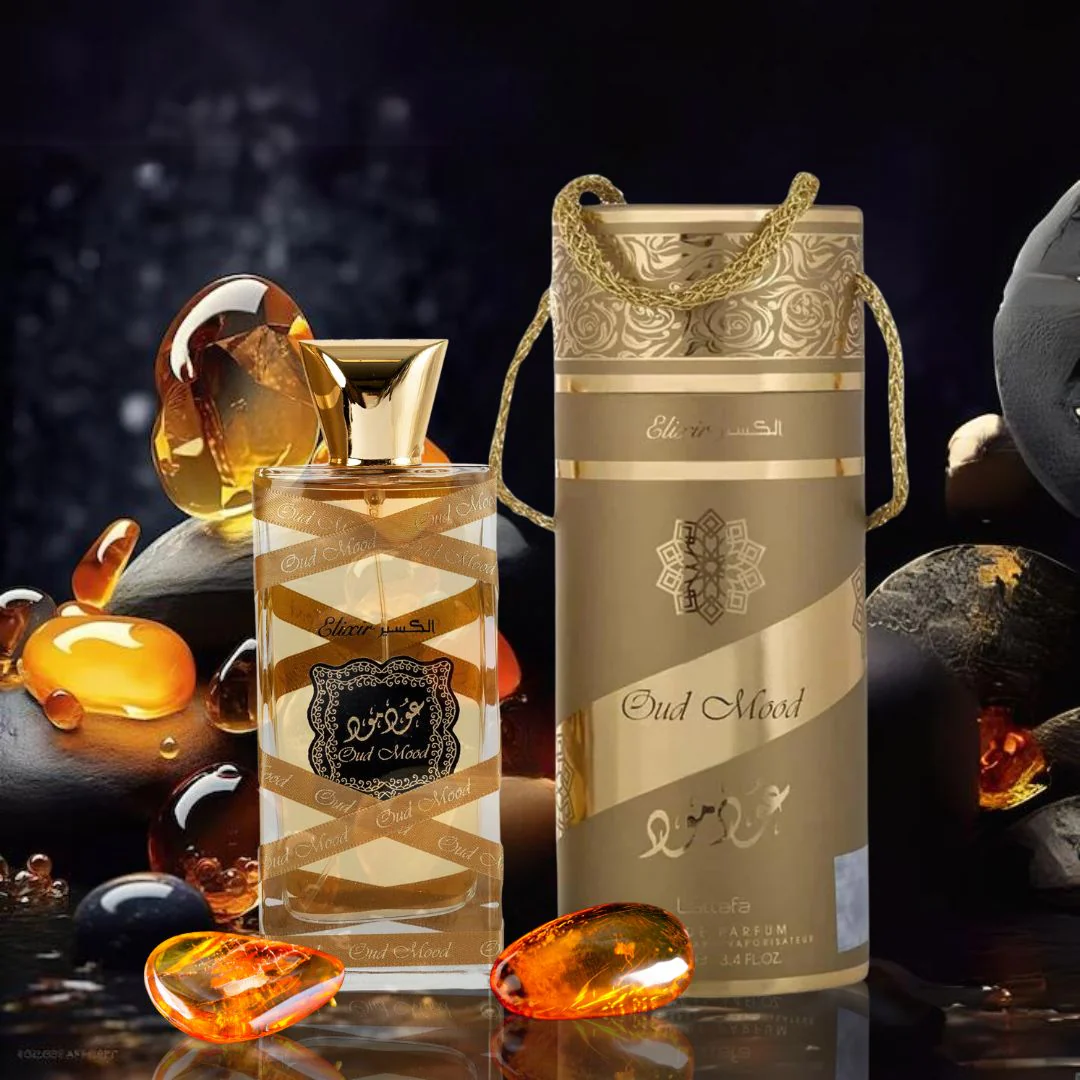 Oud Mood Elixir by Lattafa Eau de Parfum with gold bottle and matching case – luxury Arabic perfume surrounded by amber stones, symbolizing opulent oriental scent profile.
