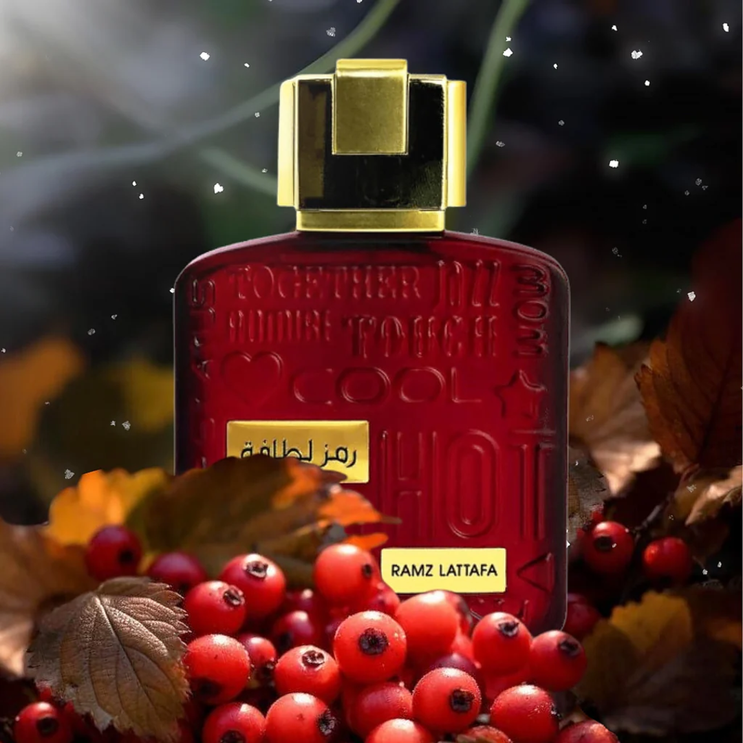Red perfume bottle with gold cap on a background of red berries and leaves. Lattafa Ramz Gold Unisex Perfume