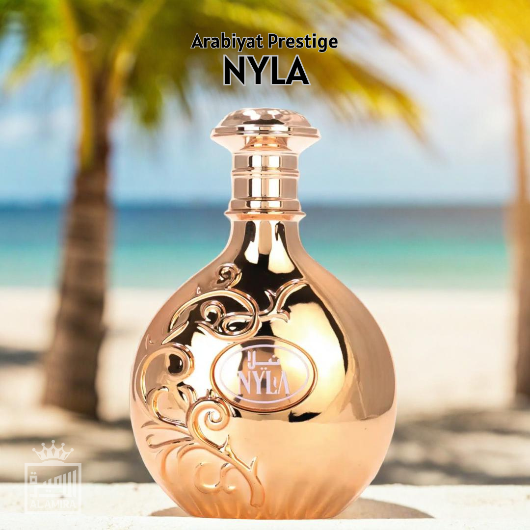Gold perfume bottle with 'Arabiyat Prestige NYLA branding on a beach background. womens perfume.