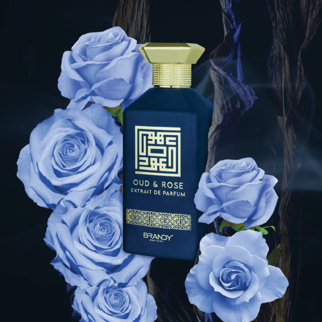 Perfume bottle labeled 'Oud & Rose' surrounded by blue roses on a dark background. Oud & Rose by Brandy Designs Unisex Perfume