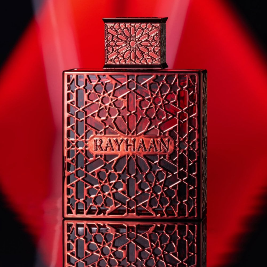 Decorative box with intricate patterns and 'RAYHAAN' branding on a red background. Rayhaan Crimson Mens Perfume