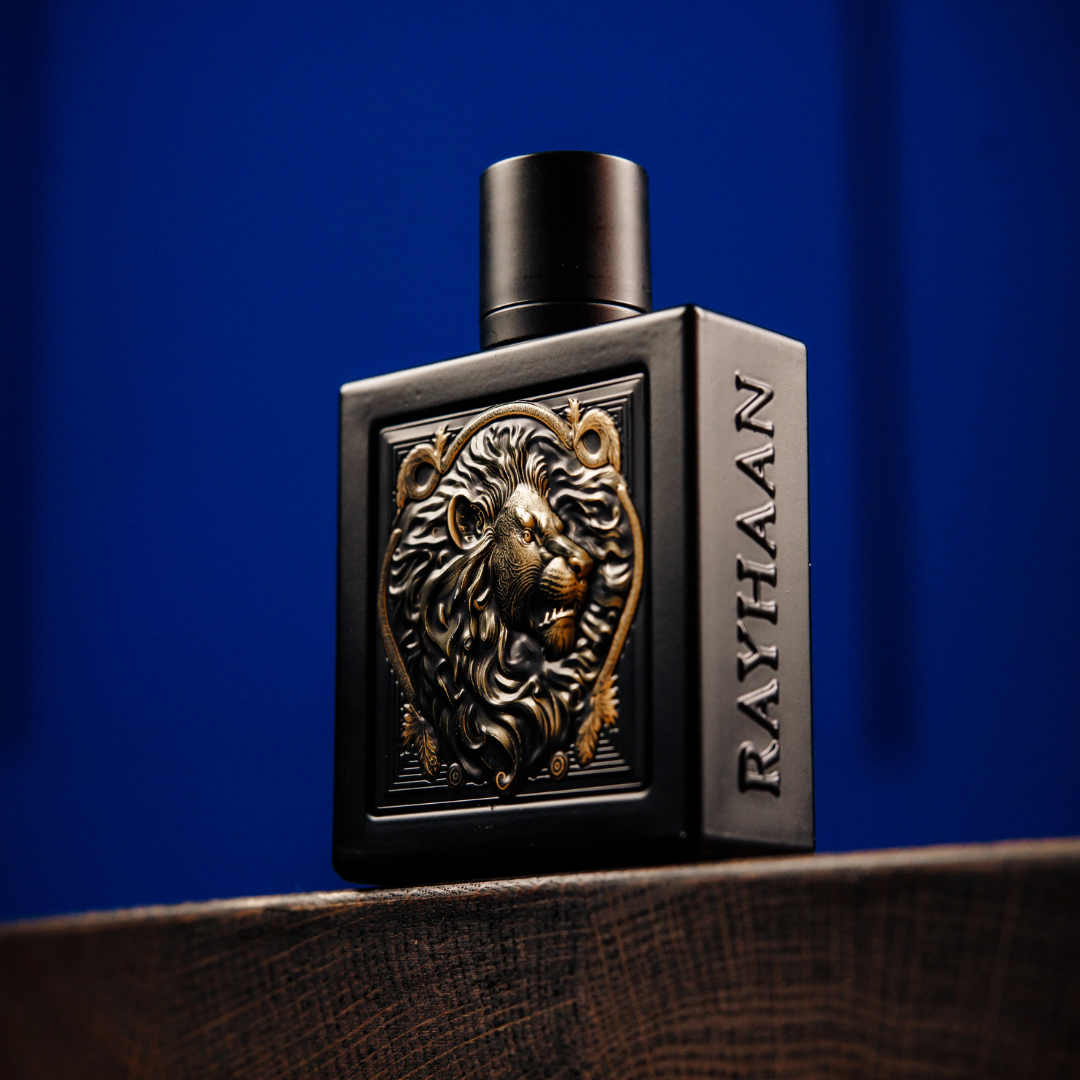 Black perfume bottle with lion emblem and 'RAYHAAN' branding on a blue background. Rayhaan Lion Mens Perfume