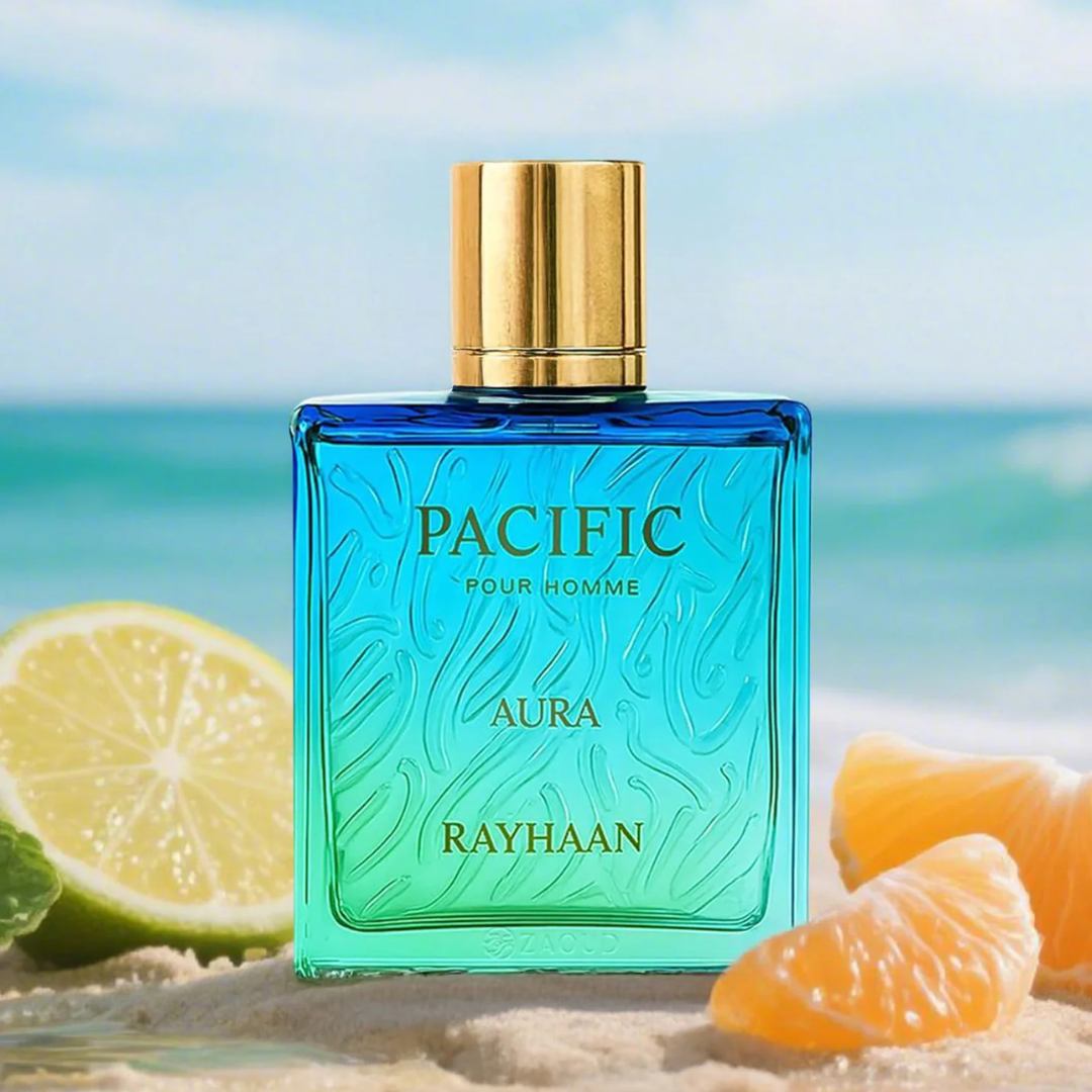 Blue perfume bottle labeled 'Pacific Pour Homme' by Rayhaan with citrus fruits on a beach background. Rayhaan Pacific Aura Mens Perfume