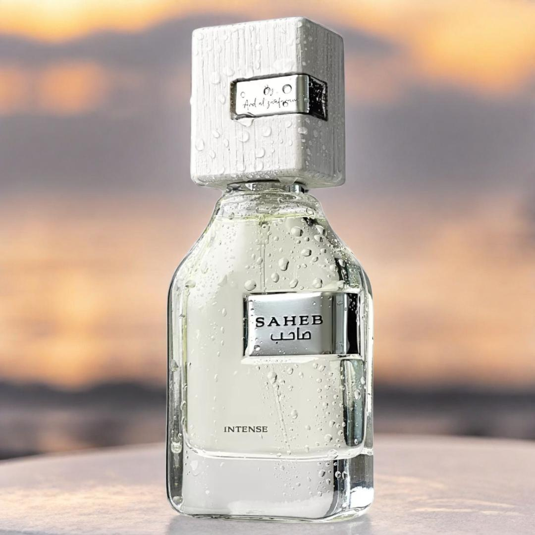 Perfume bottle labeled 'SAHEB' Intense with a blurred background. Ard Al Zaafaran. Clone / dupe of Imagination by Louis Vuitton.