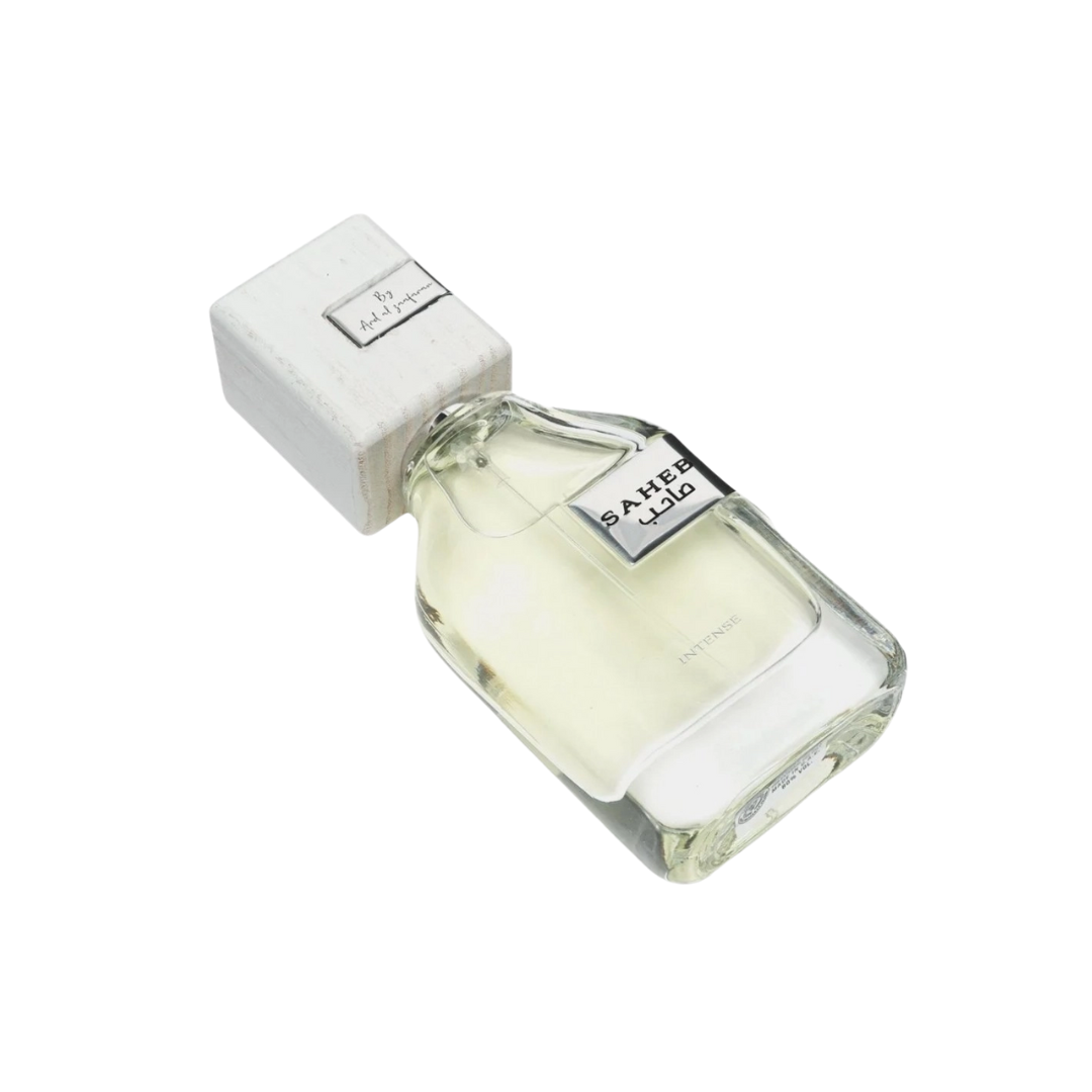 Perfume bottle with white cap and clear body on a white background. Saheb Intense. Ard Al Zaafaran. Clone / dupe of Imagination by Louis Vuitton.