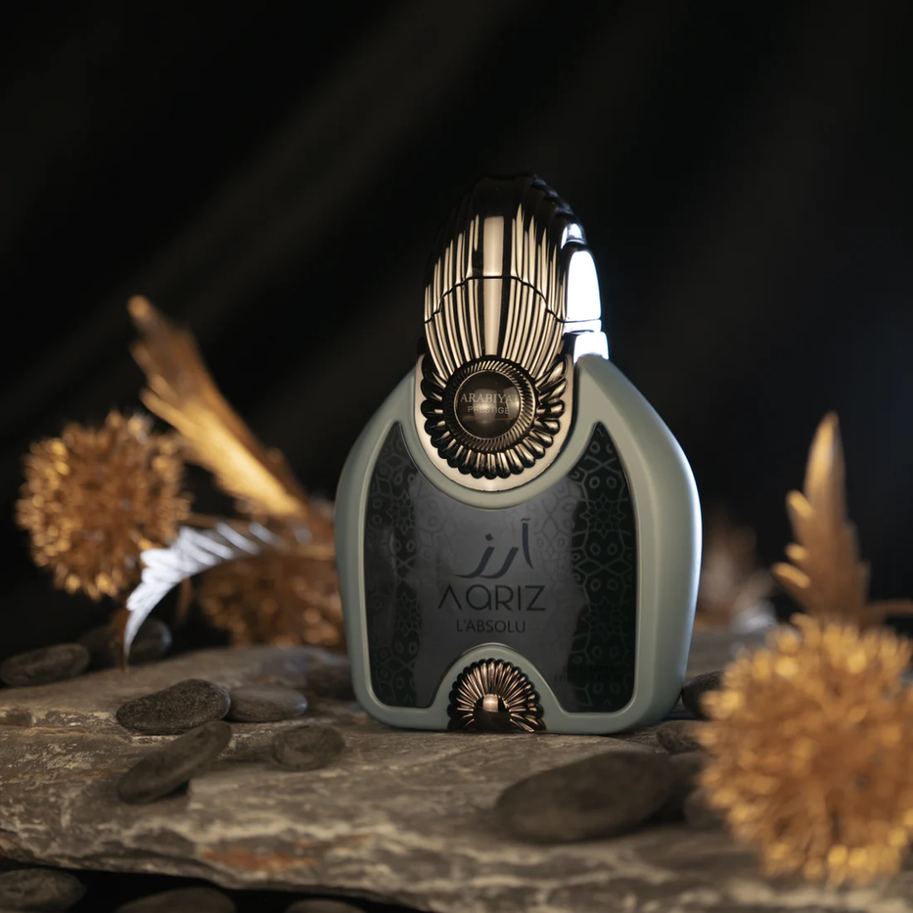 Perfume bottle with decorative design on a stone surface with blurred background. Aariz  L’Absolu by Arabiyat Prestige Unisex Perfume