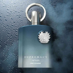 Blue perfume bottle with silver cap on a wet surface. Afnan: Supremacy Incense