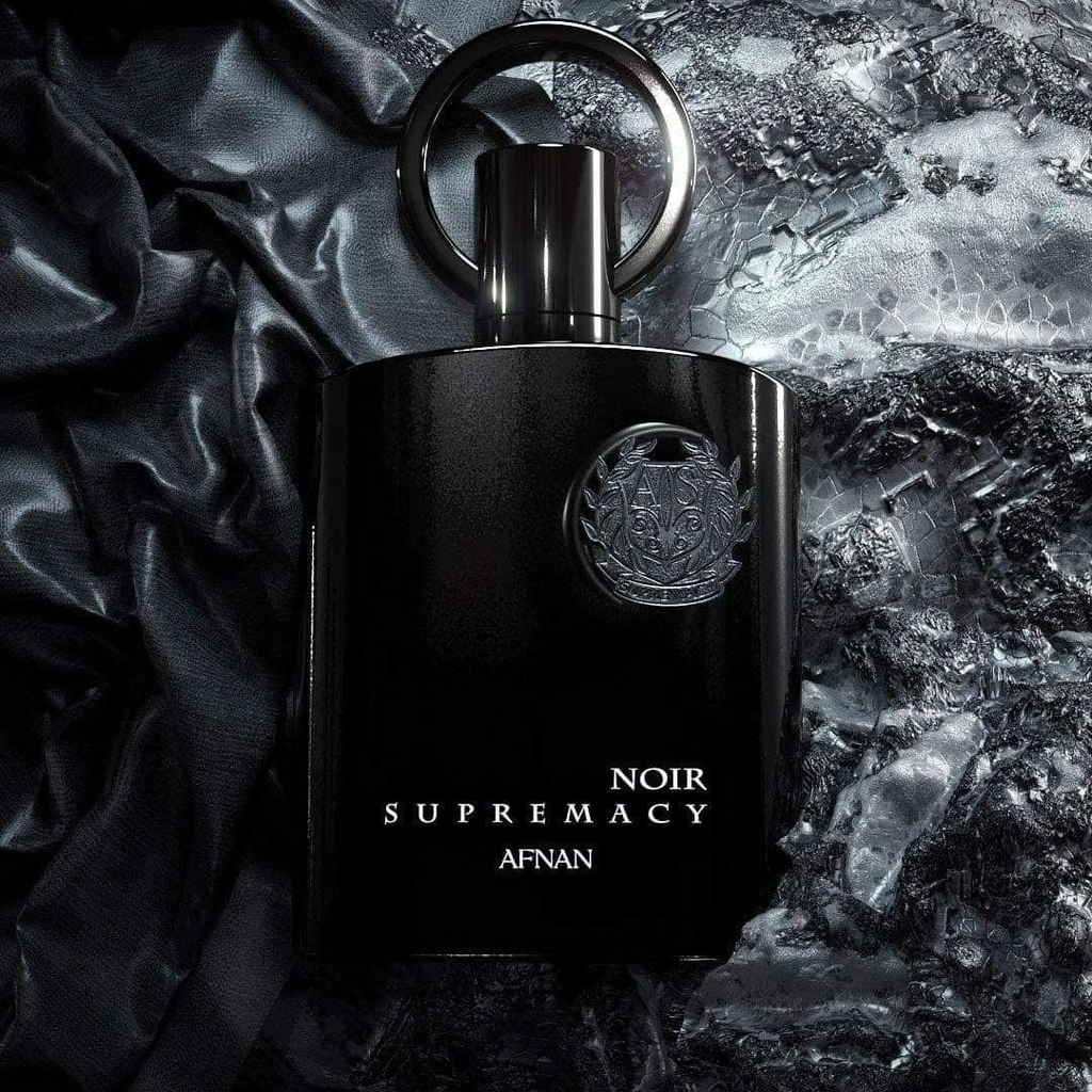 Black perfume bottle labeled 'Noir Supremacy' by Afnan on a textured dark background