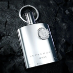 Afnan: Supremacy Silver bottle with a logo on a dark stone surface
