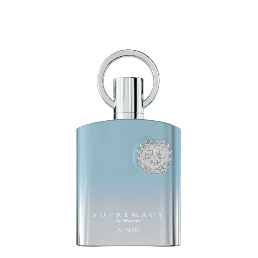 A bottle of Afnan Supremacy in Heaven fragrance, featuring a light blue gradient body with a silver metallic cap and a circular ring detail on top, set against a plain white background.