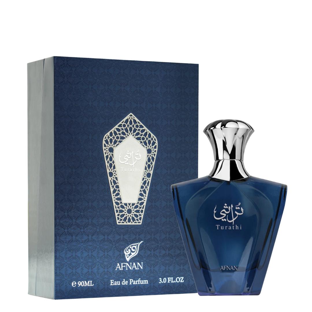 A bottle of Afnan Turathi Blue Eau de Parfum next to its blue packaging box, featuring a dark blue glass bottle with a silver cap and a matching blue box with a silver geometric emblem.