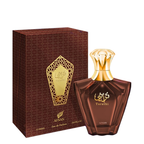 A bottle of Afnan Turathi Brown Eau de Parfum next to its dark brown patterned box with a gold label, on a plain white background.
