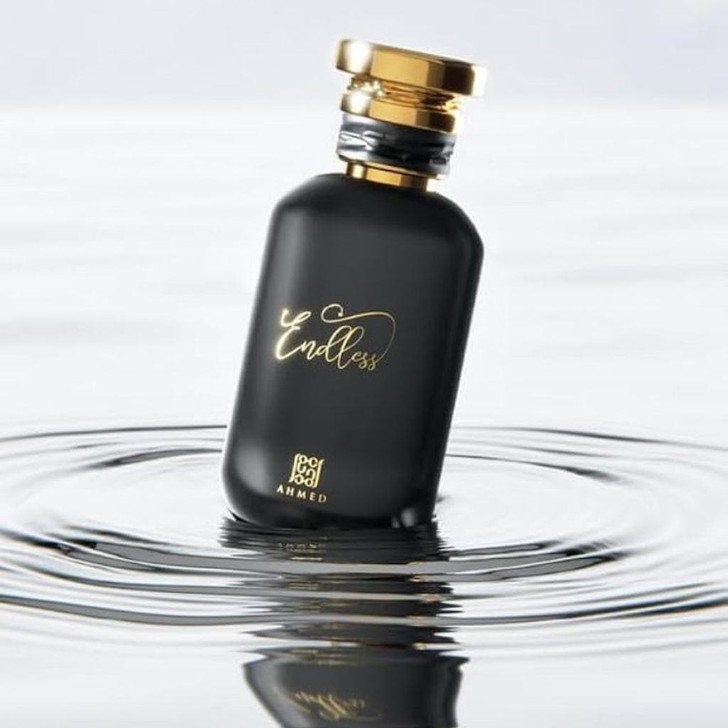 Black perfume bottle with gold cap and 'Endless' branding on a reflective surface. Ahmed Al Maghribi Endless Unisex Perfume