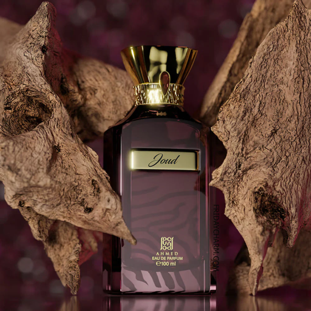 Perfume bottle with gold cap and 'Joud' branding against a textured background. Ahmed Al Maghribi Joud Unisex Perfume