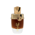 A luxurious perfume bottle with a gold-colored cap and a clear, amber-colored liquid visible. The label features Arabic calligraphy. Al Shujae by Arabiyat Prestige Unisex Perfume
