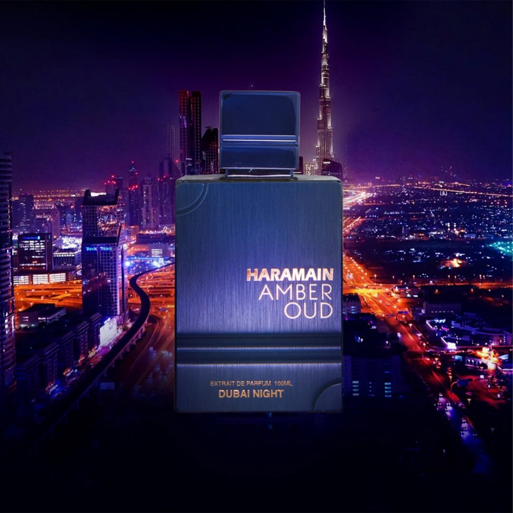 Haramain Amber Oud perfume bottle with Dubai skyline in the background. Amber Oud Dubai Night Al Haramain Mens Perfume
