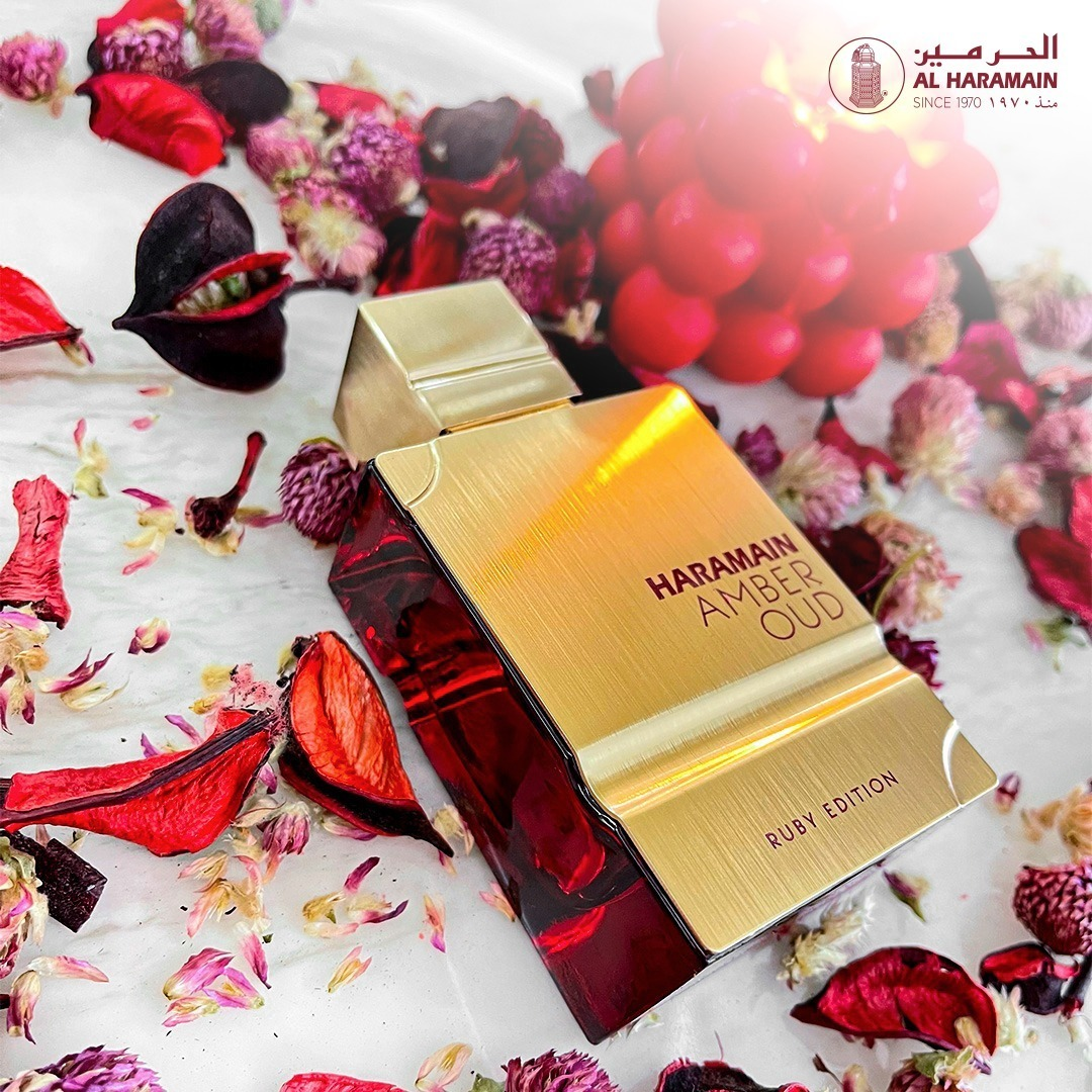 Haramain Amber Oud Ruby Edition perfume bottle on a floral background
