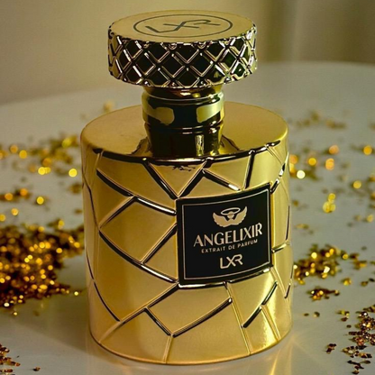 Gold perfume bottle with 'Angelixir' label on a reflective surface with gold confetti. By LXR perfumes.