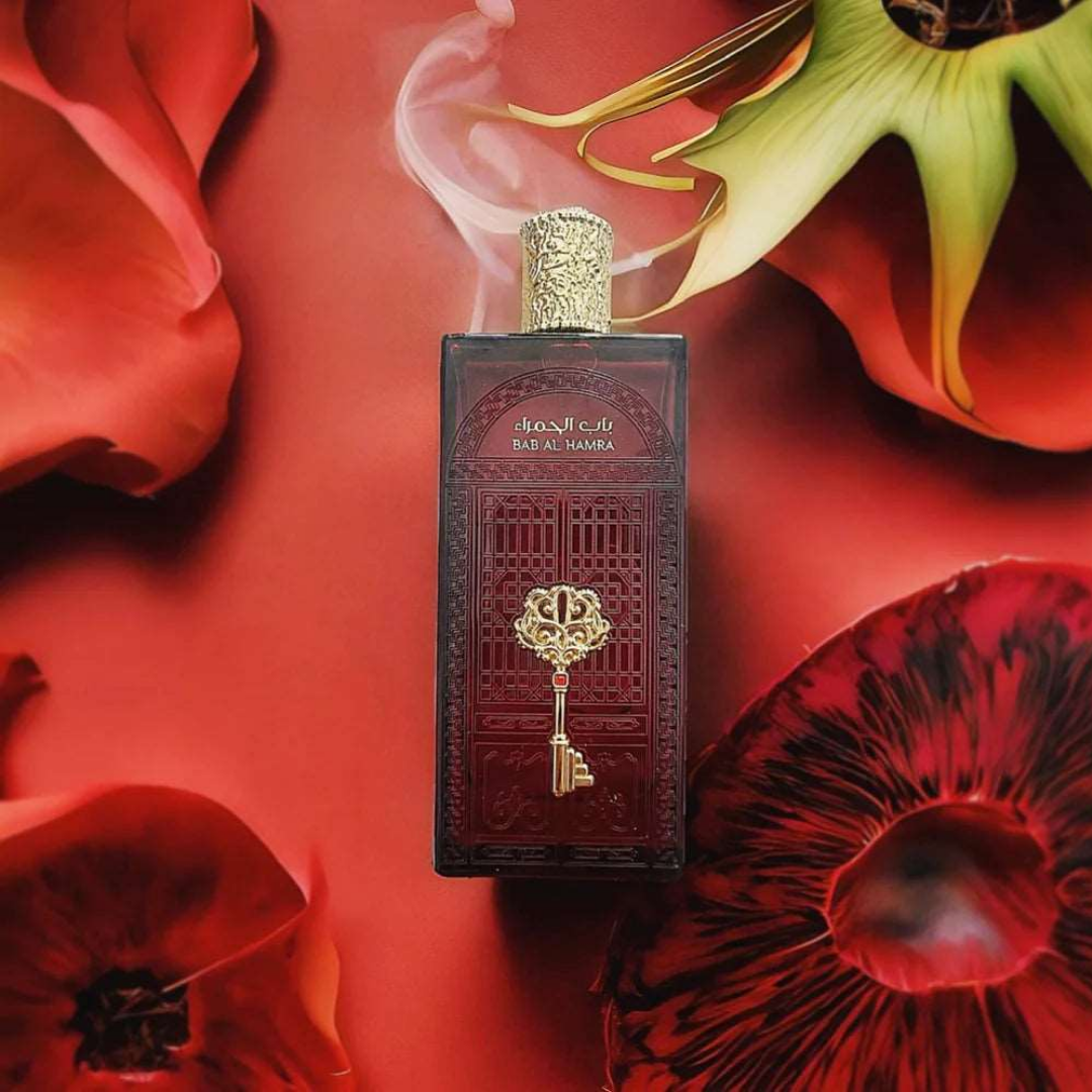 Decorative perfume bottle with intricate design on a red floral background. Bab Al Hamra by Ard Al Zaafaran Mens Perfume