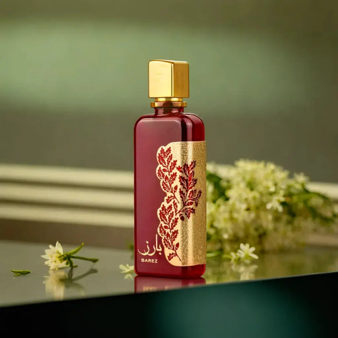 Red and gold perfume bottle with floral design on a reflective surface. Barez by Ard Al Zaafaran Unisex Perfume