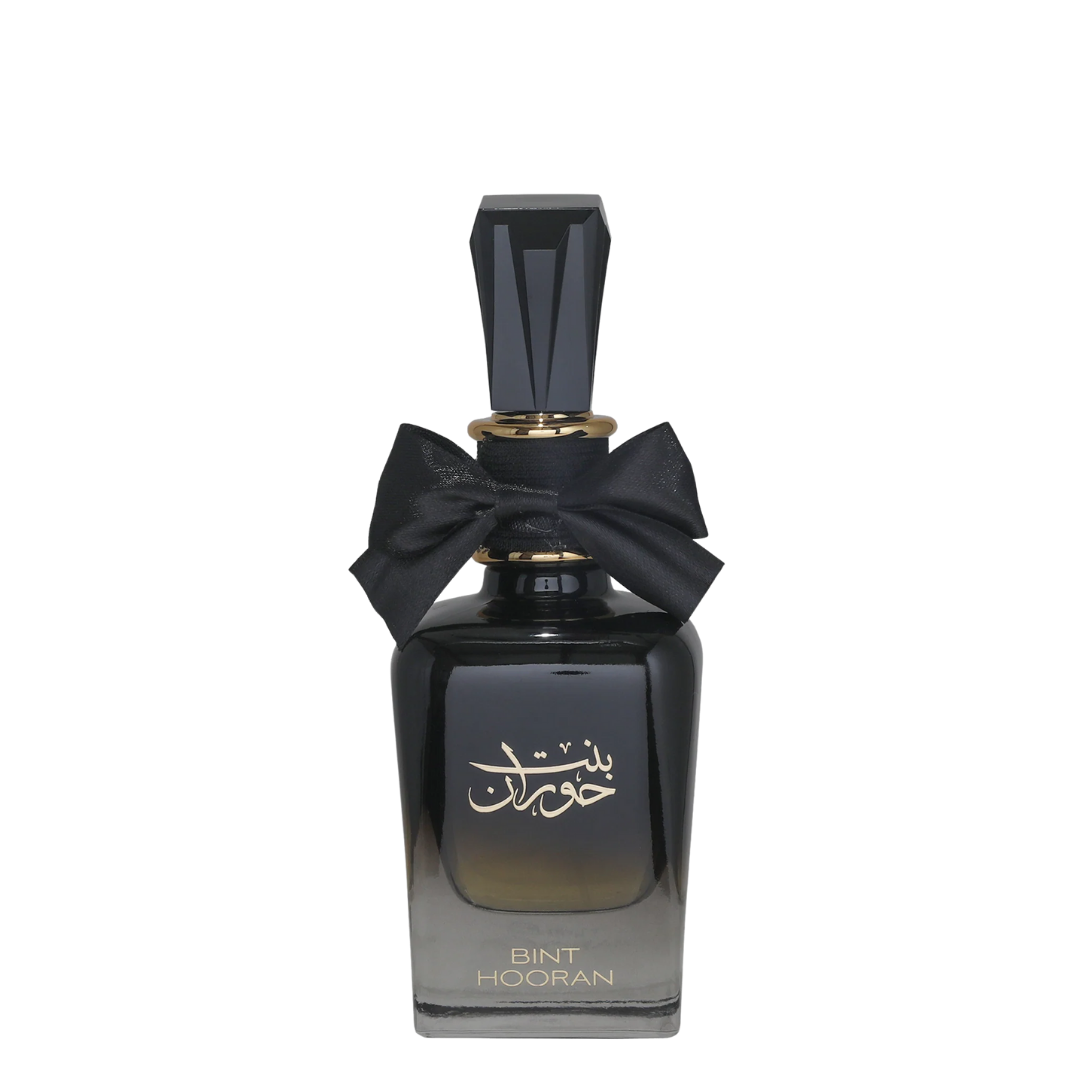A curved, black perfume bottle with a label in Arabic script, topped with a black bow. Bint Hooran Womens Perfume by Ard Al Zaafaran