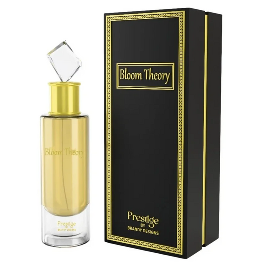 Gold perfume bottle with 'Bloom Theory' branding next to a black box with the same branding. Bloom Theory by Brandy Designs Unisex Perfume.