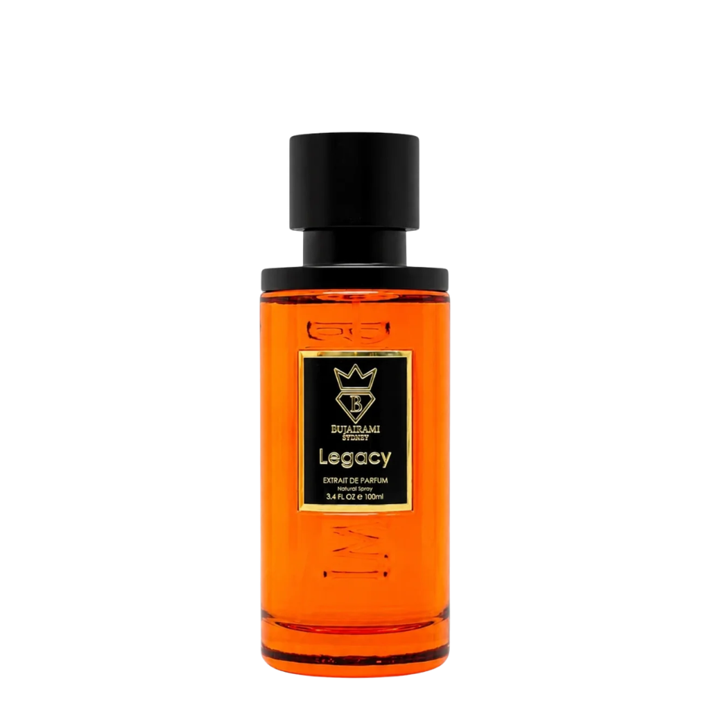 A bottle of Legacy Extrait de Parfum by Bujairami, featuring a vibrant orange liquid inside a clear glass bottle with a black cap and a black label with gold accents.