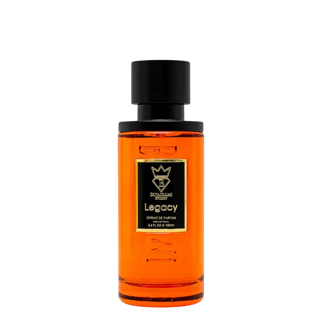 A bottle of Legacy Extrait de Parfum by Bujairami, featuring a vibrant orange liquid inside a clear glass bottle with a black cap and a black label with gold accents.