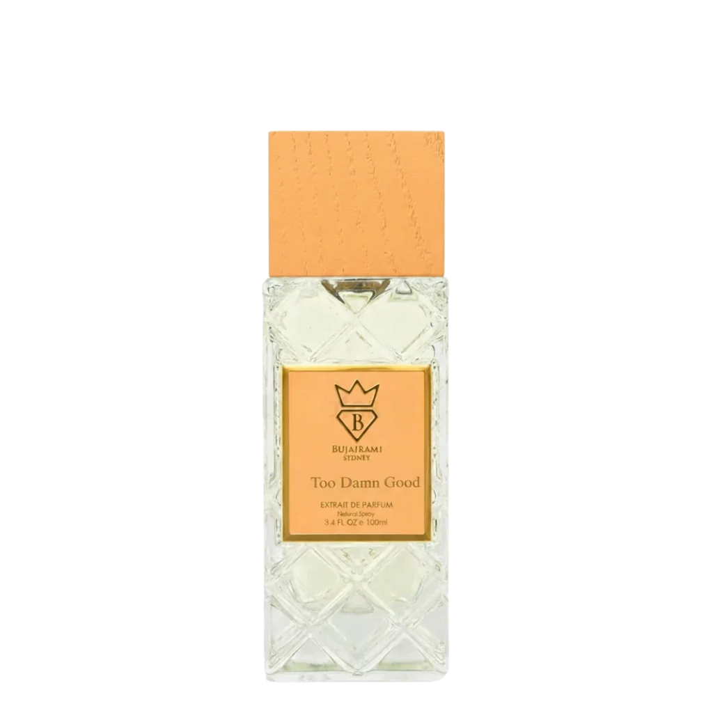 A bottle of Too Damn Good Extrait De Parfum by Bujairami, featuring a textured clear glass bottle with a light orange cap and a gold label.