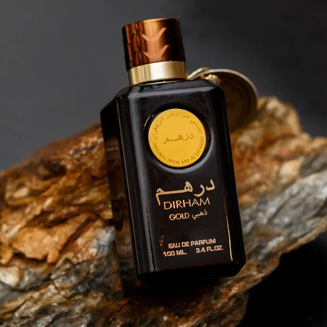 Perfume bottle labeled 'Dirham Gold' on a textured surface. Dirham Gold Unisex Perfume by Ard Al Zaafaran