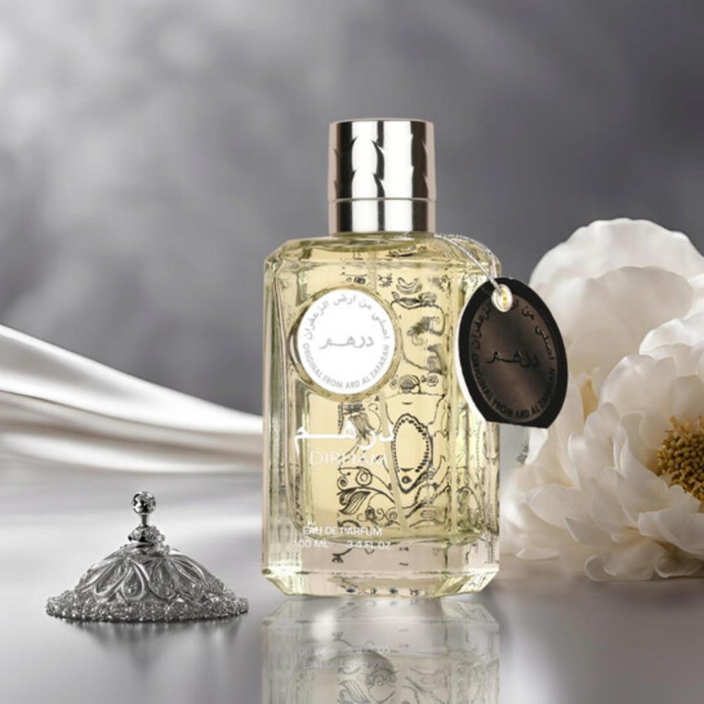 Perfume bottle with decorative label and floral elements on a soft background. Dirham Silver Unisex Perfume by Ard Al Zaafaran