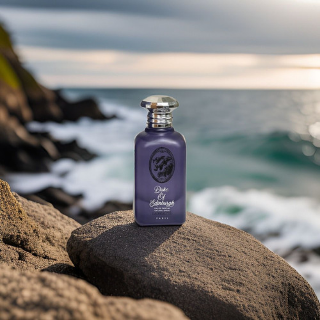 Purple bottle of Duke of Edinburgh cologne on a rock with ocean background