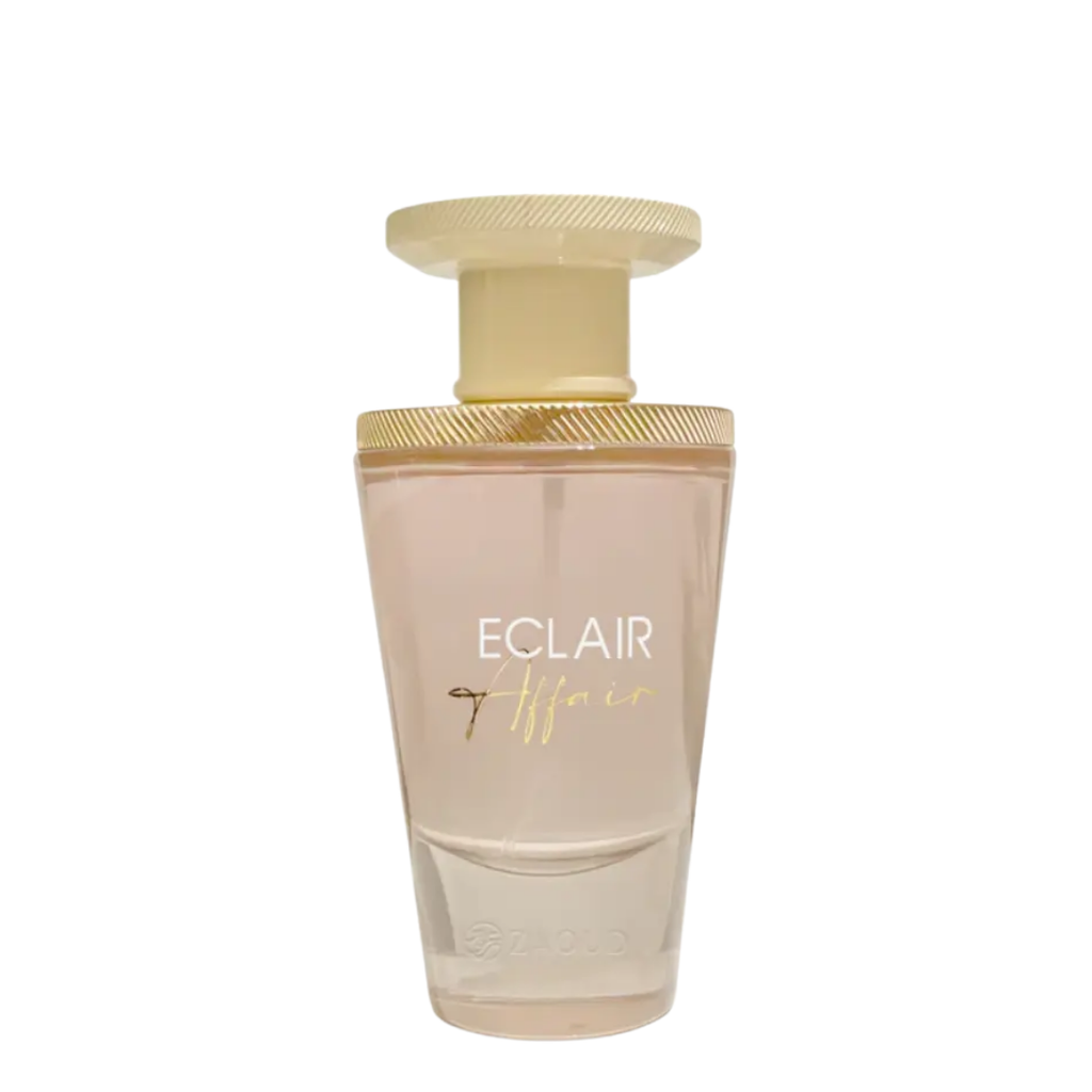 A bottle of Eclair Affair perfume with a pink hue and a golden cap, labeled with the product name.