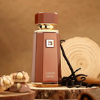 Brown perfume bottle labeled 'LIQUID BRUN' with vanilla beans on a wooden surface.