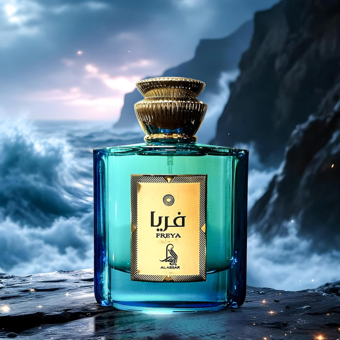 Blue perfume bottle with gold cap on a mountainous background