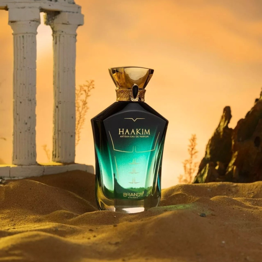 Haakim brandy bottle in sand with classical architecture in the background. Haakim by Brandy Designs Mens Perfume