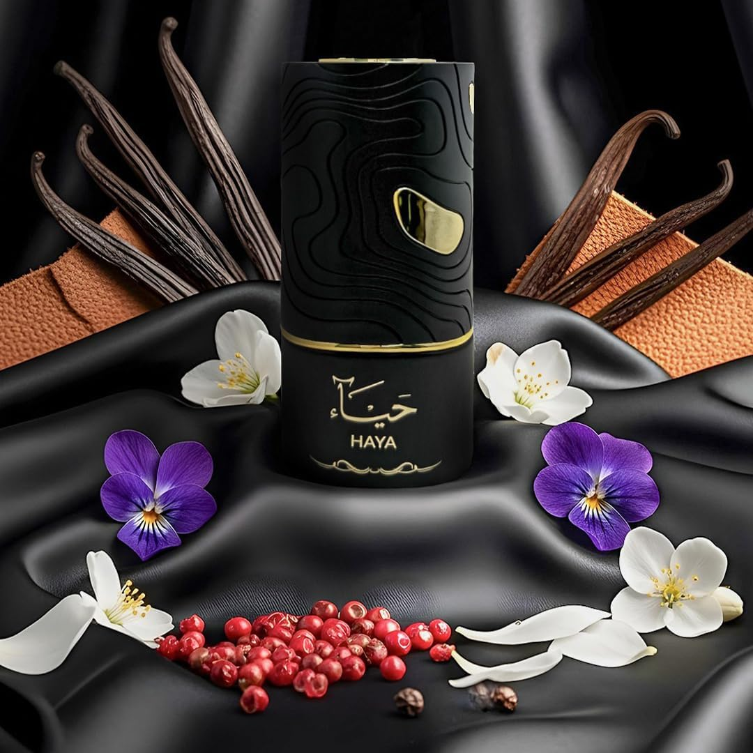 Black HAYA product with vanilla beans, flowers, and red berries on a black background