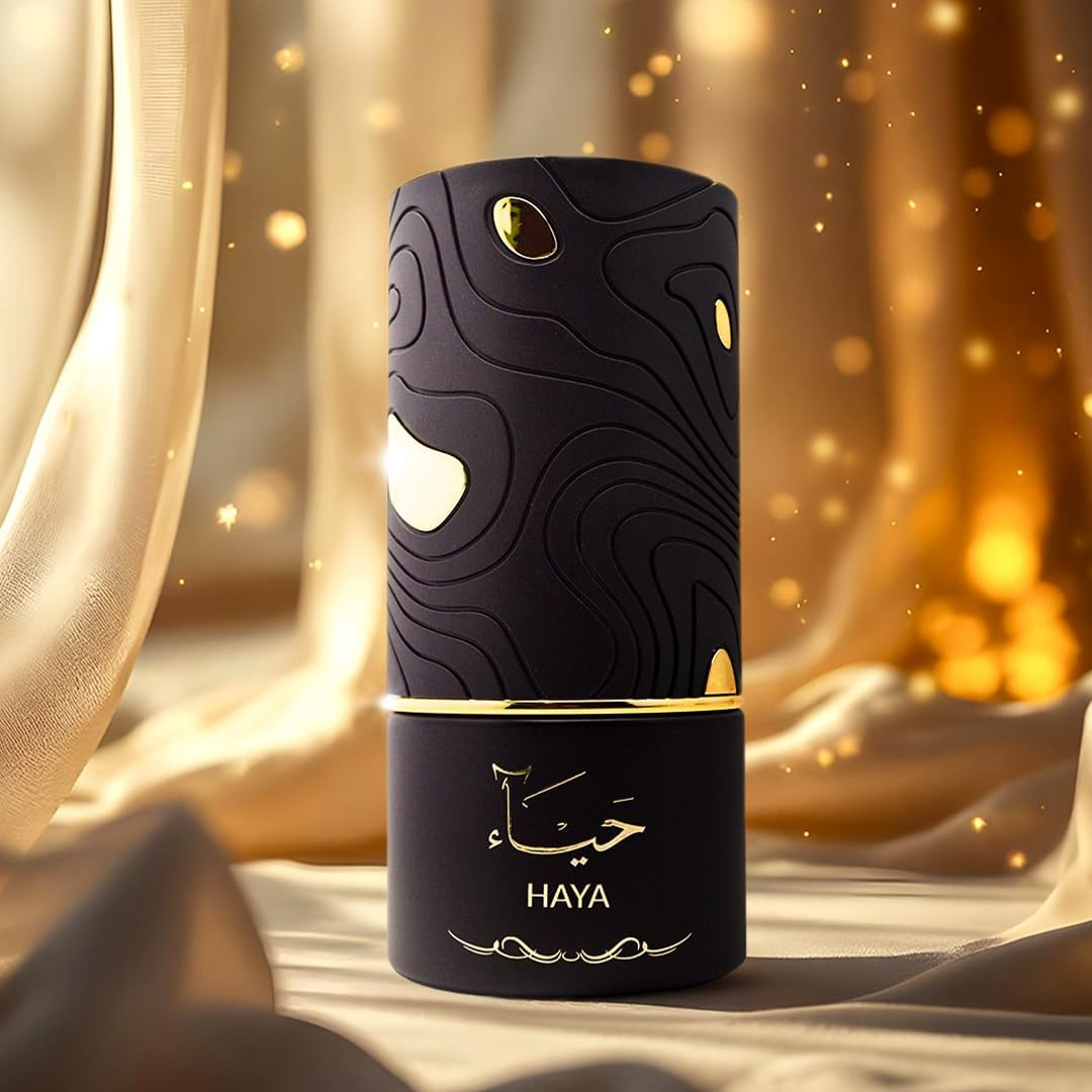 Black cylindrical product with gold accents on a textured surface, featuring the brand 'HAYA'.